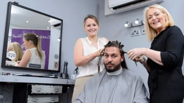 Mario Falcone having his hair cut