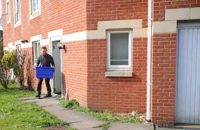 
          A police officer leaves a home in Quayside, Winson Green, Birmingham,
        