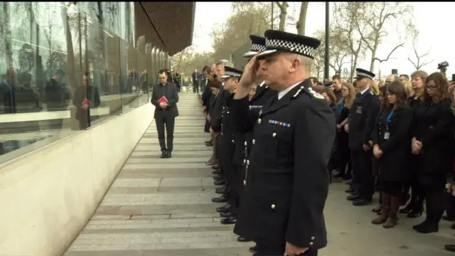 
          Police officers observe a minute's silence outside Scotland Yard
        