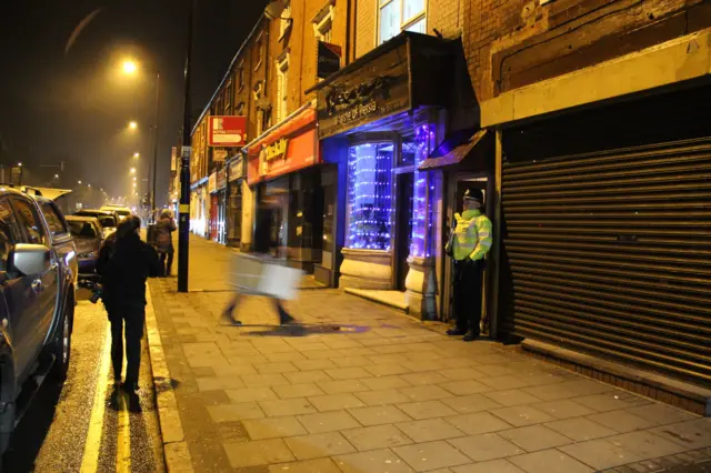 Police officer outside address in Hagley Road, Birmingham