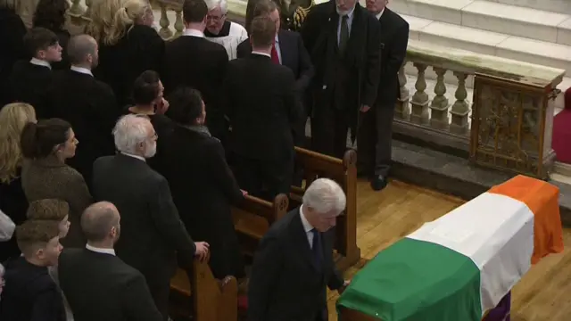 clinton touches coffin