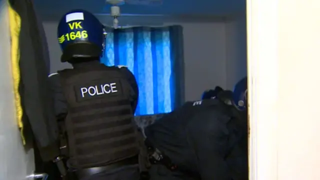 Police officer enters room