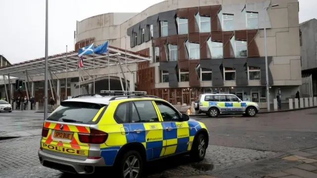 police vehicles outside Holyrood