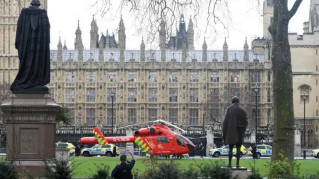 Helicopter on green outside Westminster