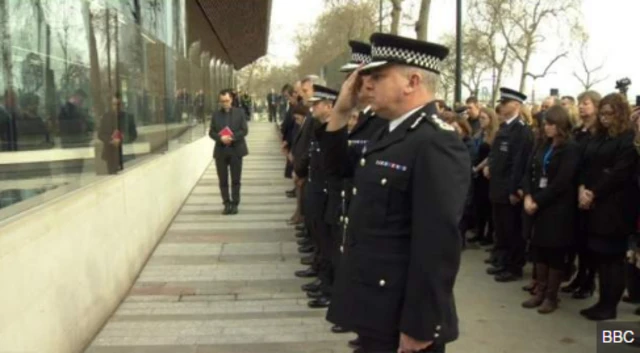 Police at Scotland yard observing minute's silence