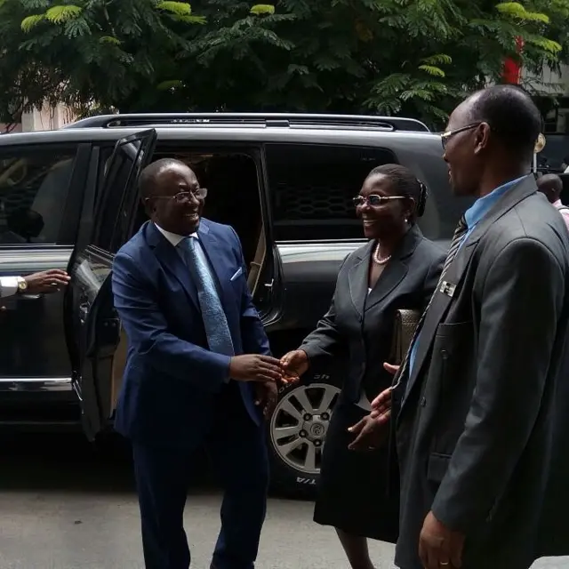 Man shaking hands with officials