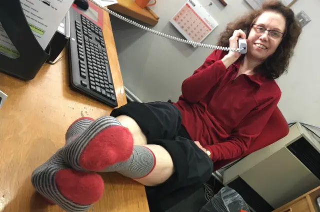 Receptionist with her red socks