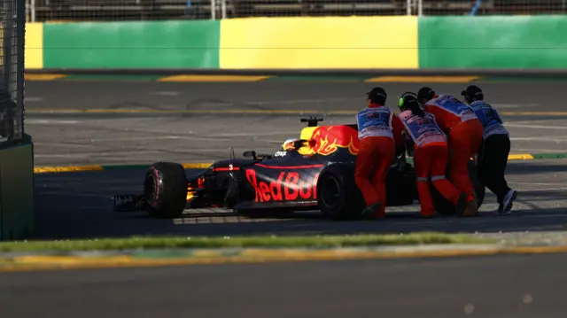 Ricciardo's car is pushed off the track