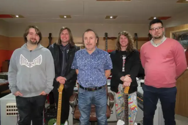 
          John Cochlan, in blue shirt and blue jeans, with the rock band Walkway
        