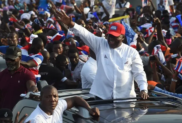 
          Nana Akufo-Addo waves to supporters from his car during a campaign rally of the party in Accra, on December 4, 2016,
        