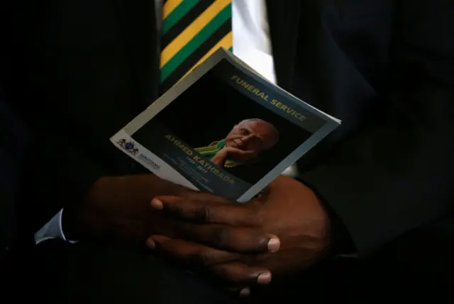 Man holding memorial booklet