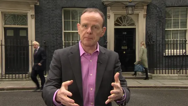 The BBC's Norman Smith, with Boris Johnson in the background