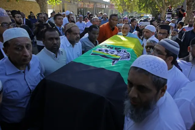 Mourners carrying the coffin