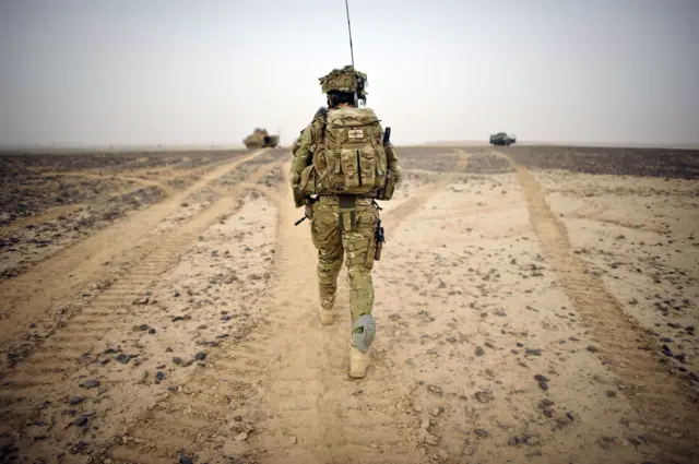 
          British soldier walks towards observation point in Helmand Province, March 2012
        