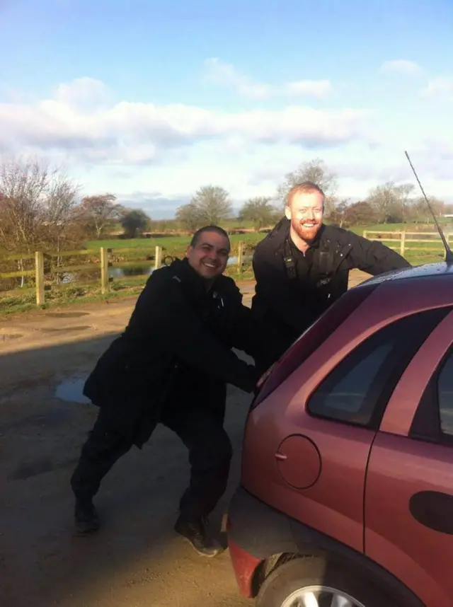 Officers push car