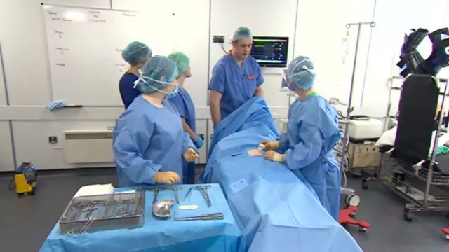 Students practising in operating theatre