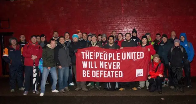 Group of walkers holding flag