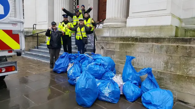 Volunteers with bags of litter