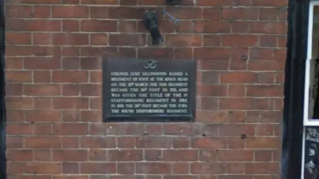 Plaque on wall of pub marking its history