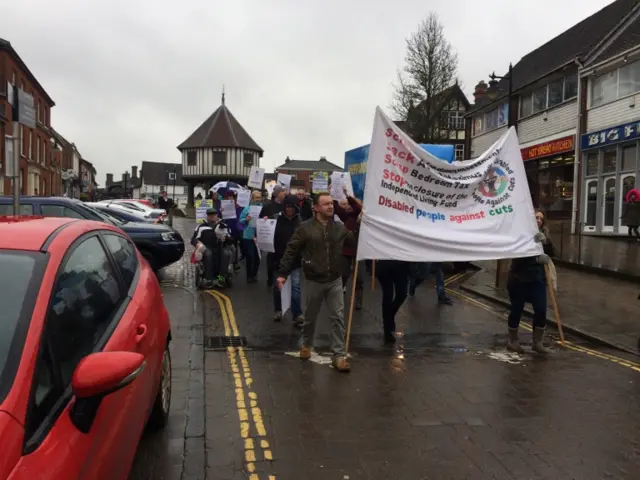 Protestors with banners march through Wymondham