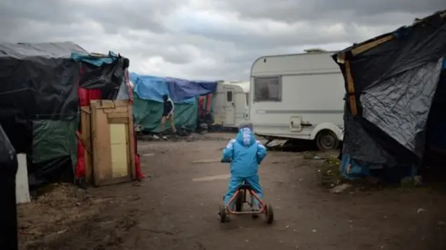 Child playing in migrant camp