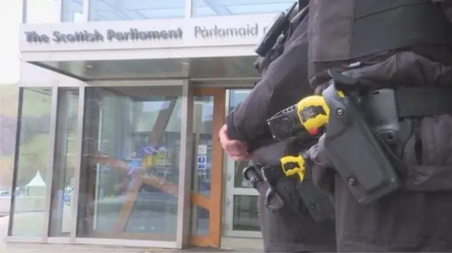 Officer with taser outside Holyrood