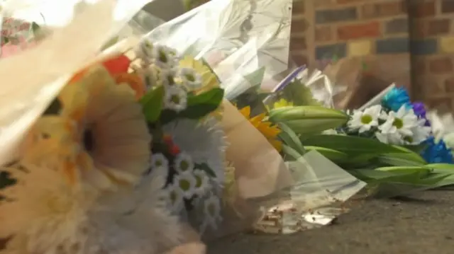 
          Flowers left following the deaths of a mother and son in Norton
        