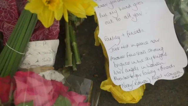 
          Message on flowers saying "rest in peace - another few stars shining brighter in the sky tonight"
        