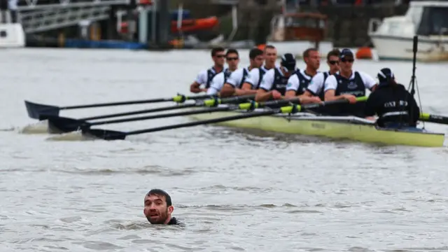 Protester in the water of boat race