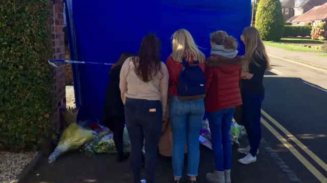 
          School friends of Pierce Wilkinson stand outside the family home in Norton
        