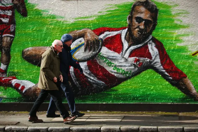 
          Fans make their way to the ground ahead of the Aviva Premiership match between Gloucester Rugby and Harlequins at Kingsholm
        