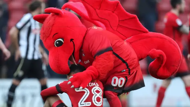 Leyton Orient's mascot comforts Josh Koroma