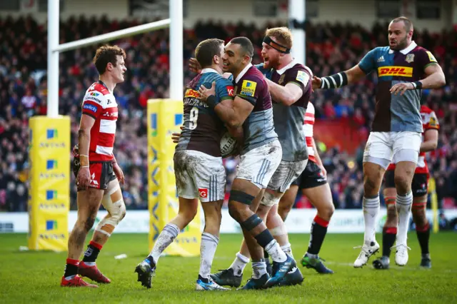 
          Charlie Mulchrone of Harlequins celebrates with his teammates after scoring a try during the Aviva Premiership
        