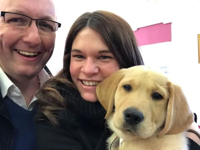 Lizzie Rose and Carl Wheatley with a puppy