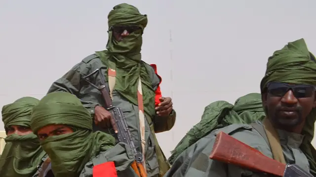 
          Malian army soldiers, pro-government militia members and former rebels, predominantly Tuaregs, take part in their first joint patrol in Gao in northern Mali
        