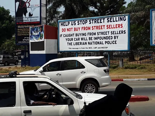 A sign urging motorists in Liberia to boycott street sellers