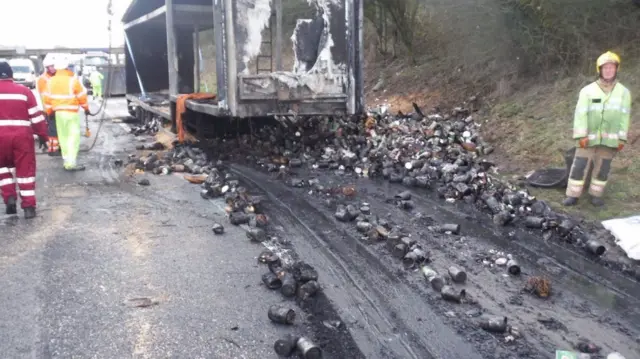 Debris of burnt cans on road