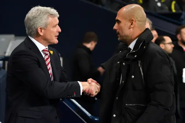 
          Pep Guardiola (R) shakes hands with Stoke City"s manager Mark Hughes
        