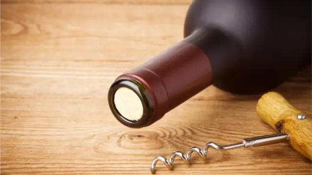 Bottle of wine and corkscrew