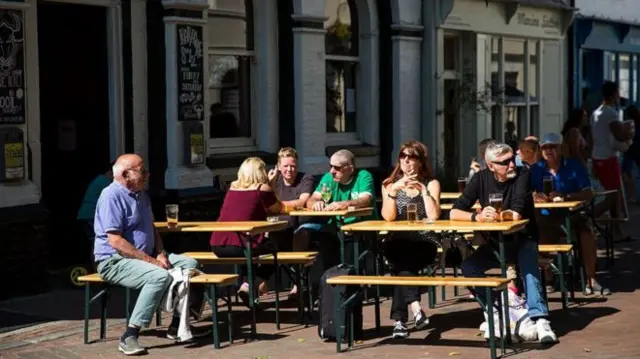 People siting outside a pub