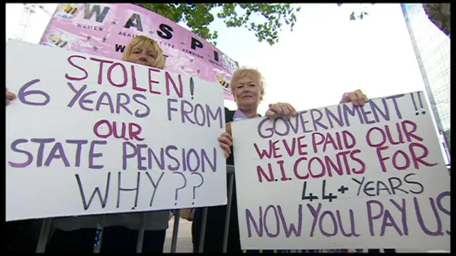 Women holding up plaquards