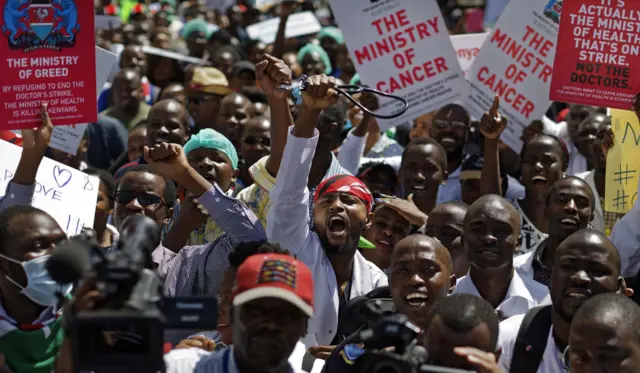 
          A doctor holds his stethoscope in the air as he and other medical staff protest the detention of their union leaders, outside an appeal court in Nairobi, Kenya, Wednesday, Feb. 15, 2017
        