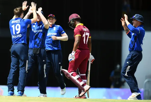 Evin Lewis walks off after losing his wicket