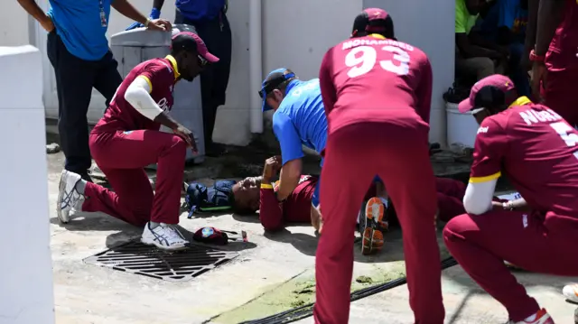 Evin Lewis receives treatment after a fall