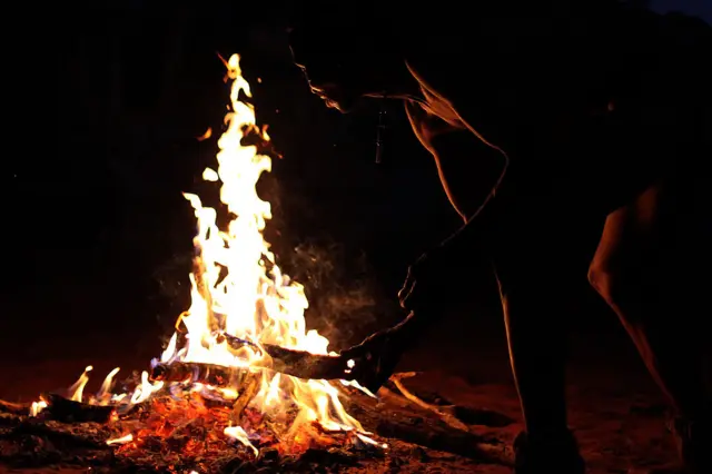 
          A San Bushmen from the Khomani San community lights a fire in the Southern Kalahari desert
        