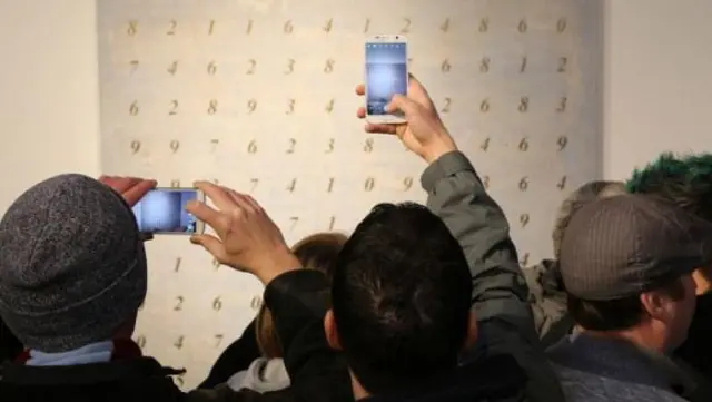 Crowd inspects the white painting at the 2021 centre