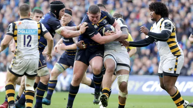 
          Leinster's Tadhg Furlong and Sean O'Brien with Nathan Hughes of Wasps
        