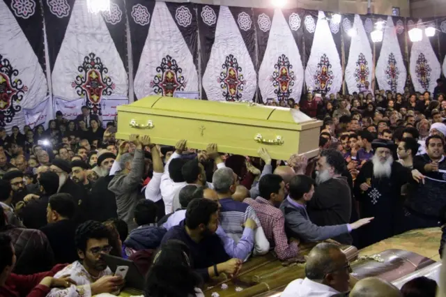 
          gyptian Christians gather around and carry coffins during the late night funeral of the victims of a blast which killed worshippers attending Palm Sunday mass at the Mar Girgis Coptic Orthodox Church in the Nile Delta City of Tanta, 120 kilometres (75 miles) north of Cairo, on April 9, 2017.
        