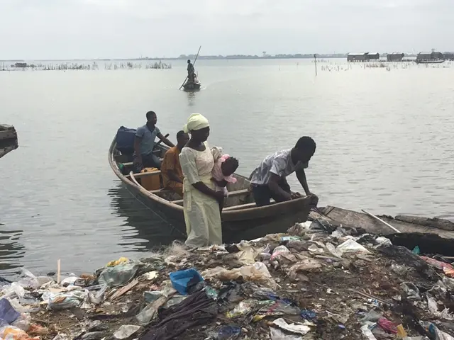 
          Woman and baby on a boat next to a shore covered with rubbish
        