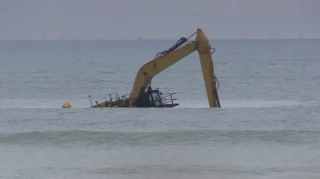 Digger in the sea off Worthing